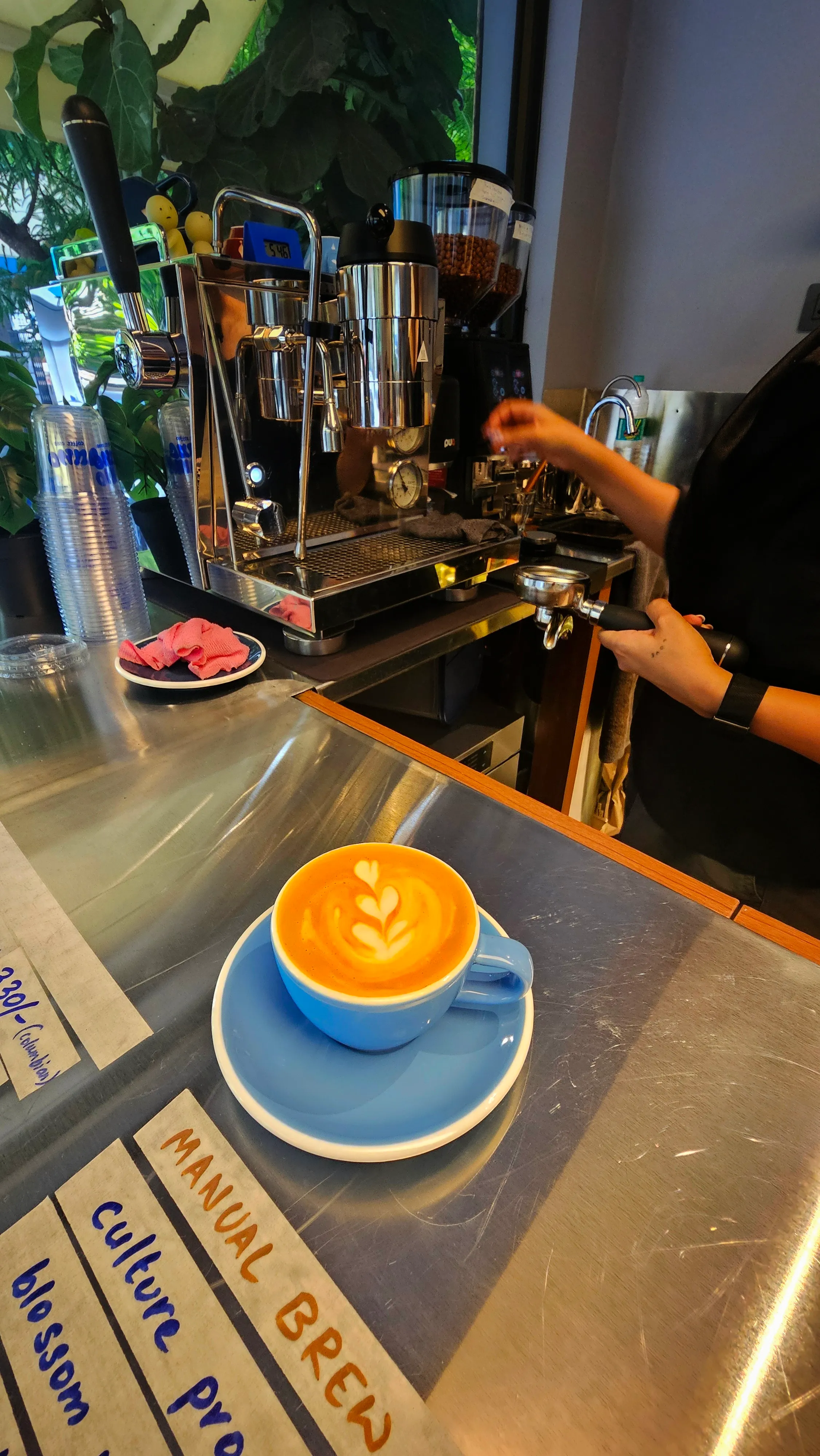 Latte art poured at Juno Coffee Club