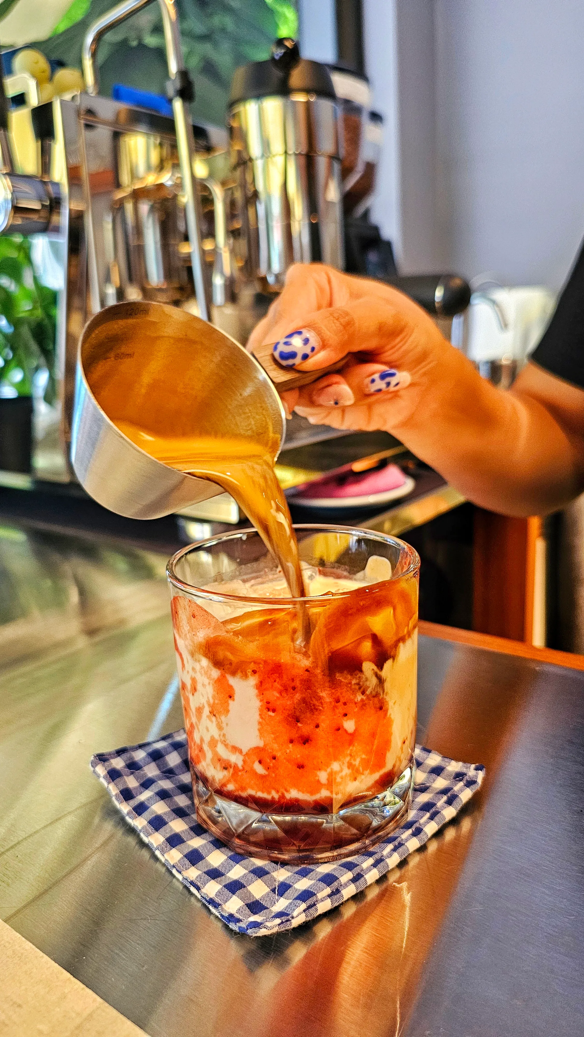 Pouring the PBJ iced latte at Juno Coffee Club